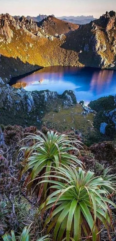 Serene mountain lake with lush greenery and rugged peaks.