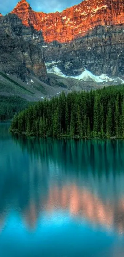 Serene mountain lake at sunset with vibrant colors reflecting on water.