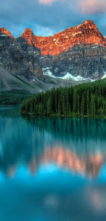 Mountain lake with trees and glowing peaks in the background.