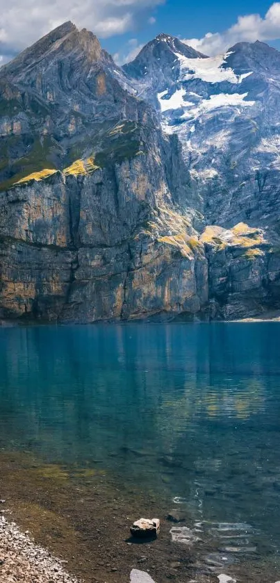 Scenic view of a mountain lake with clear blue water and towering peaks.