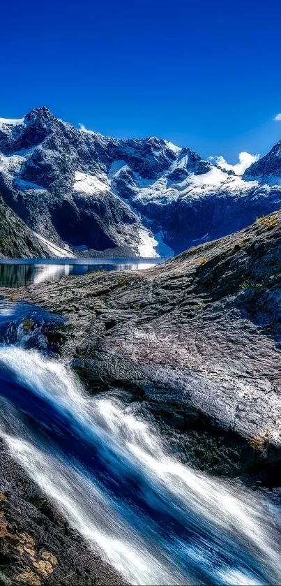 Vibrant mountain landscape with blue sky and waterfall on mobile wallpaper.