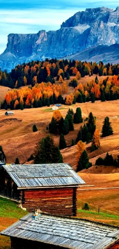 Autumn landscape with cabins and mountain view.