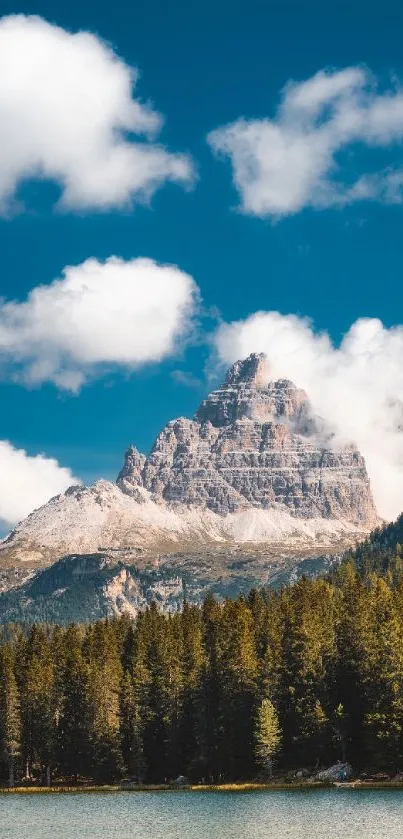 Mountain landscape with blue sky, lake, and forest in a serene setting.