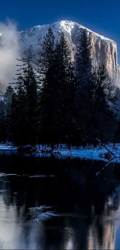 A serene mountain landscape with snow, trees, and a calm reflective river.