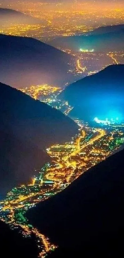 Breathtaking night view of a glowing cityscape in a mountain valley.