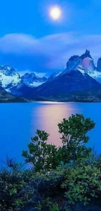 Peaceful blue mountain nightscape with glowing moon.