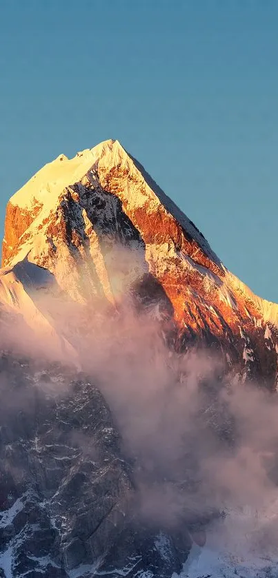 Majestic sunlit mountain peak at sunset with calming sky.