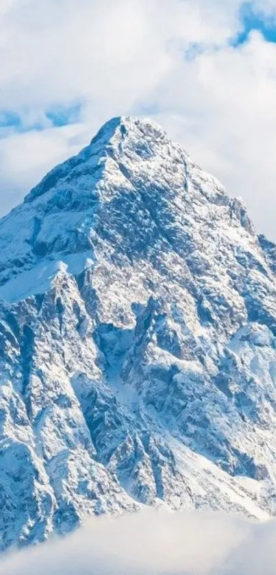 Snowy mountain peak under clear blue sky.