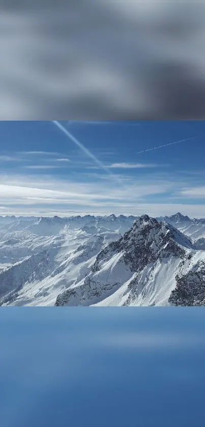 Snowy mountain range under a blue sky wallpaper.