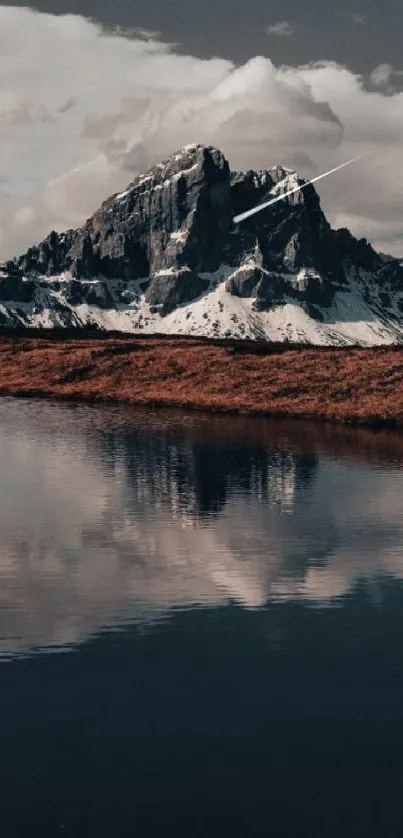 Majestic mountain reflection on a tranquil lake with snowy peaks in the background.