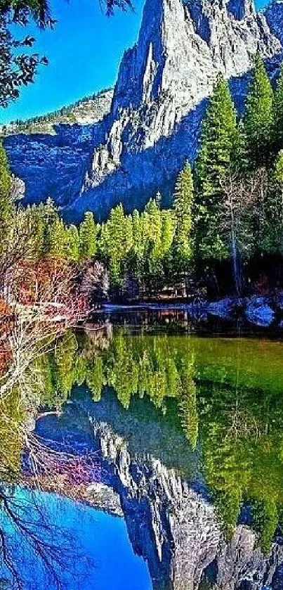 Stunning mountain reflection in a serene lake with lush greenery and blue skies.