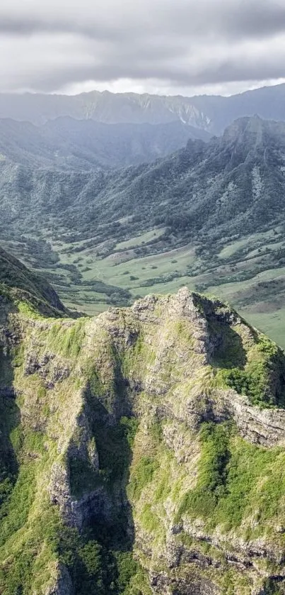 A stunning view of lush mountain ridges under a cloudy sky.