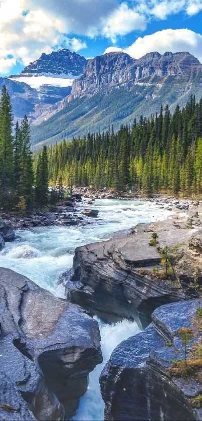 Mountain river flowing through forest with distant mountains under clear blue sky.