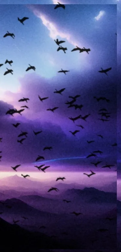 Purple sunset sky with flock of birds over mountains.