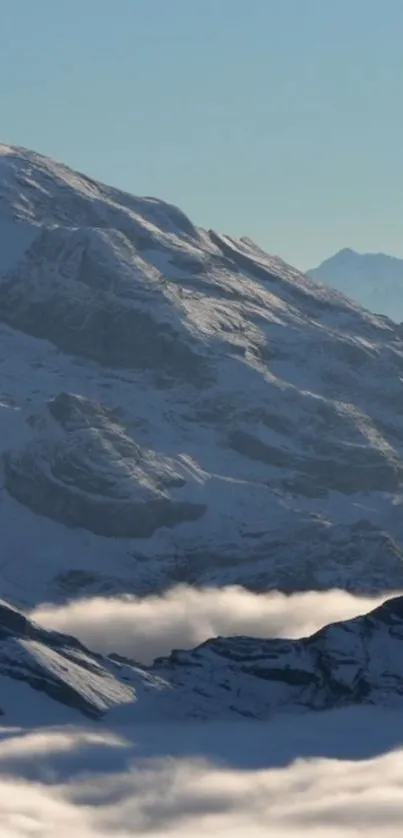 Snow-covered mountain peaks under a clear blue sky.