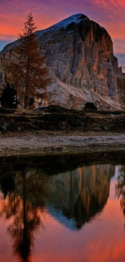 Mountain sunset reflected in serene lake with vibrant colors.