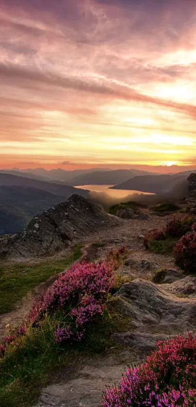 Mountain sunset with vibrant sky and rocky terrain.