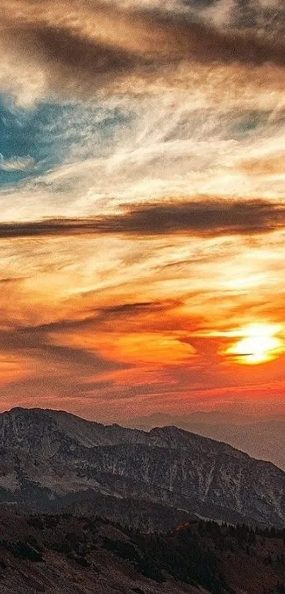 Mountain sunset with vibrant orange sky and scenic landscape.