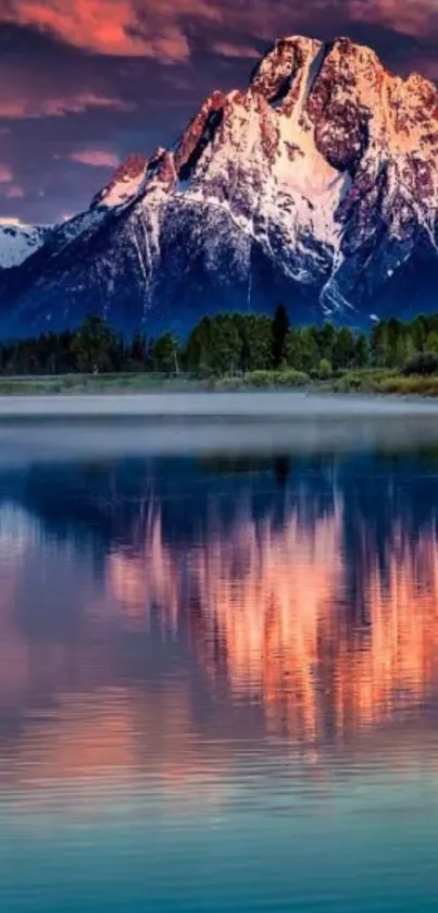 Mountain and lake at sunset with pink and purple sky.