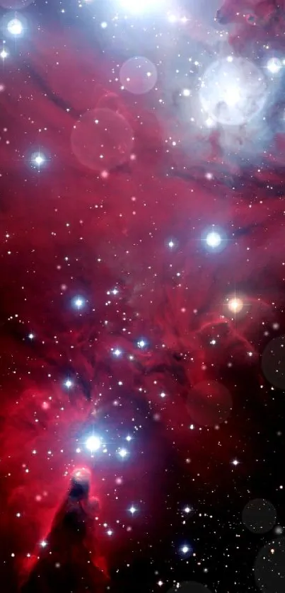 Crimson red nebula with bright stars in space.