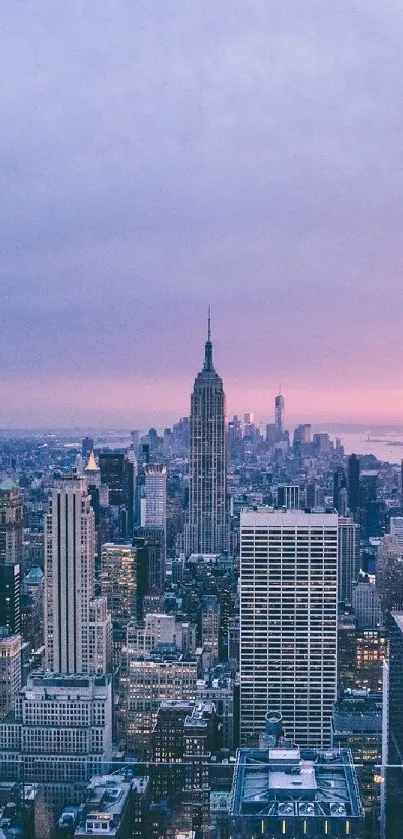 New York City skyline at dusk with purple and pink sky hues.