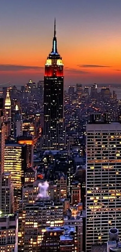 New York City skyline at sunset with vibrant lights.