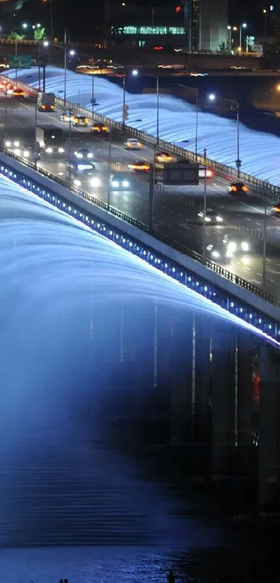 Illuminated bridge with waterfall effect at night, showcasing vibrant blue lights.