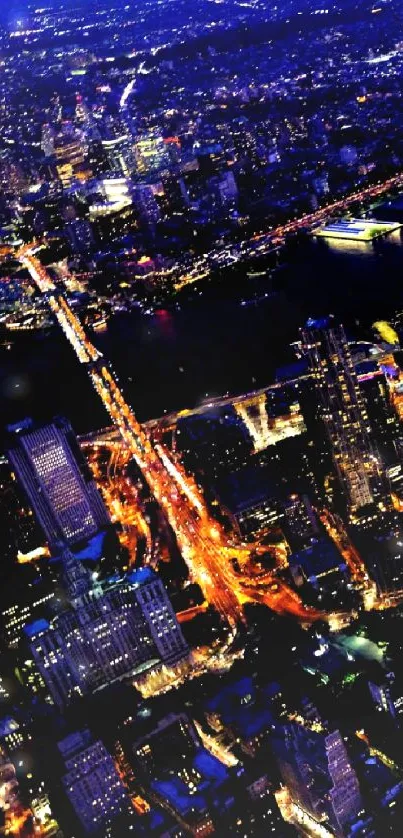 Aerial view of a vibrant city skyline at night with glowing lights.