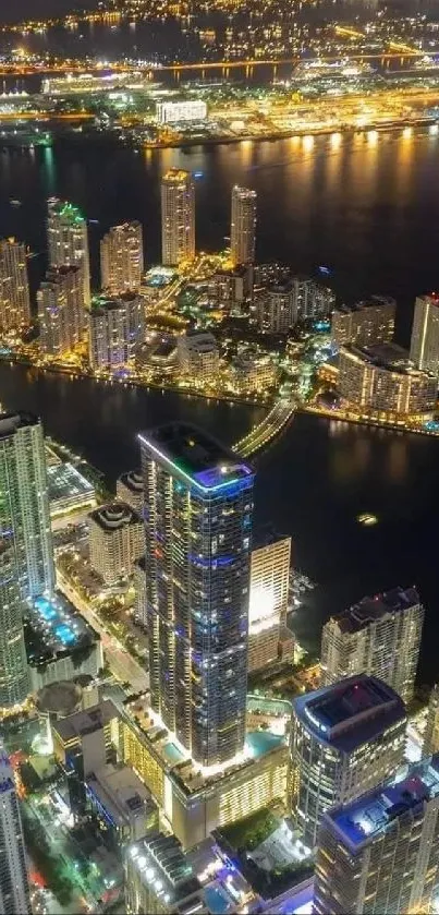 Aerial night cityscape with glowing high-rise buildings and vibrant city lights.