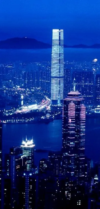 A vibrant night cityscape with illuminated skyscrapers against a dark blue sky.