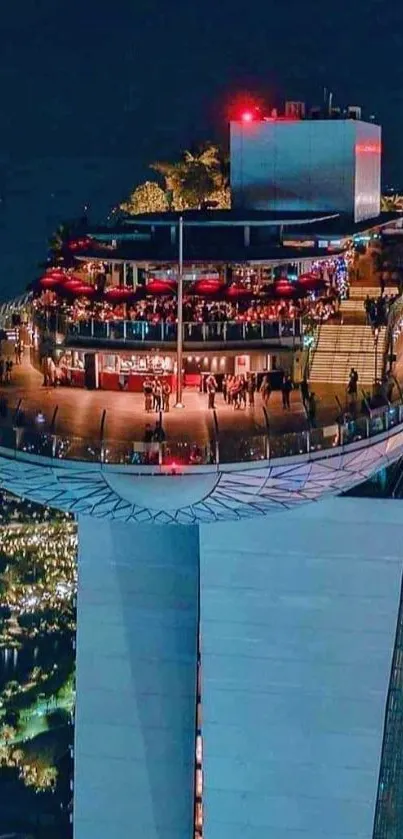 High angle view of illuminated rooftop bar on skyscraper at night.