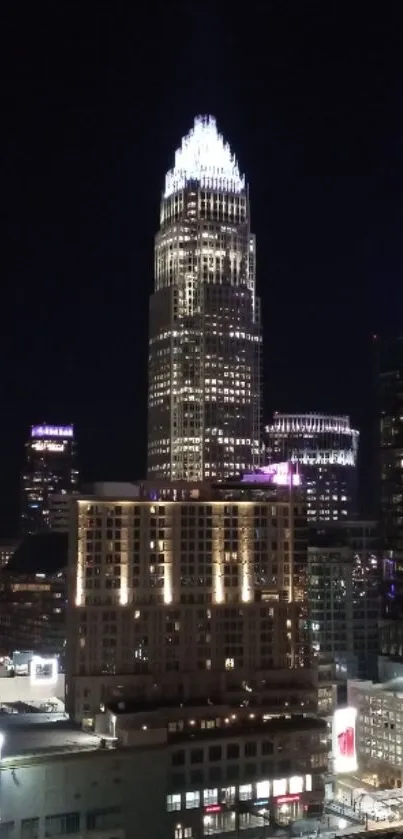 Vibrant city skyline at night with illuminated skyscrapers.