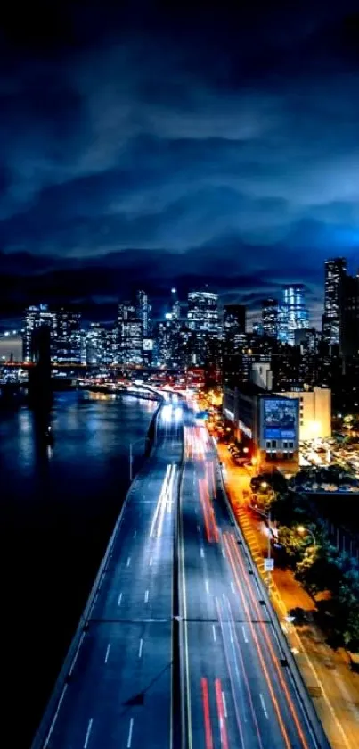 Night cityscape with skyscrapers and street lights under a dark, clouded sky.