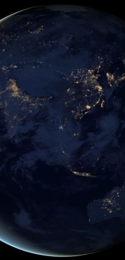 Night view of Earth from space with illuminated continents.