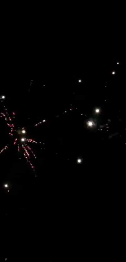 Night sky fireworks with bright sparks and dark background.