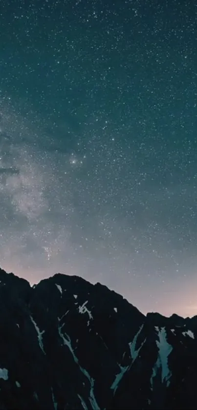 Starry night sky with mountains silhouetted in the foreground, creating a peaceful scene.