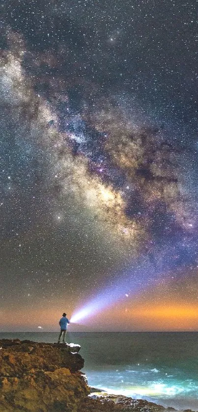 Person with flashlight under a starry night sky with the Milky Way.