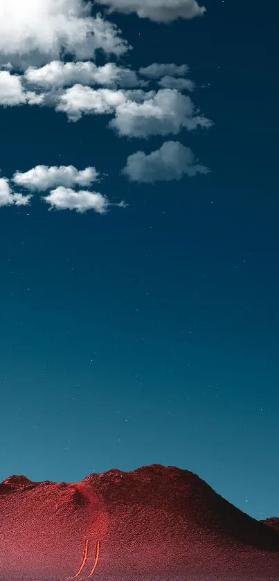 Red desert mountain beneath starry night sky with clouds.