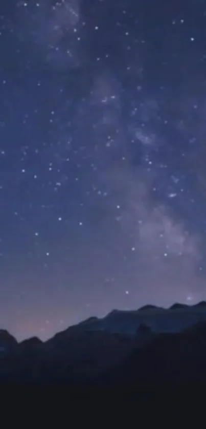 Starry night sky with mountains and Milky Way.