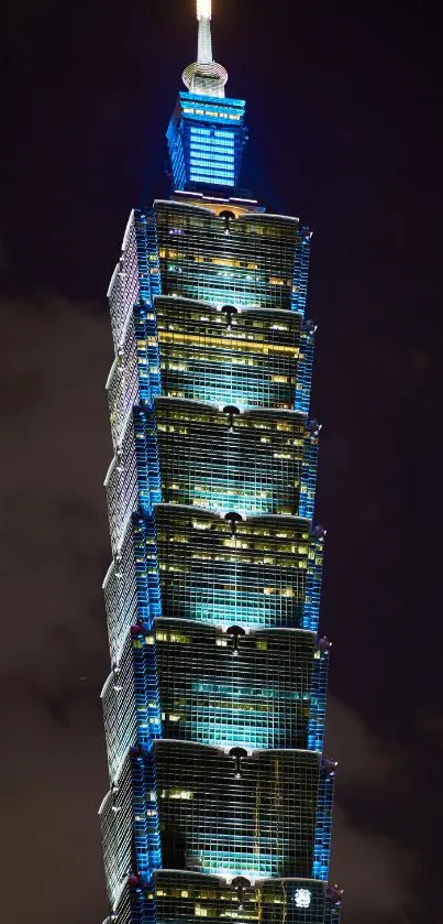 Mobile wallpaper of a beautifully illuminated skyscraper at night.