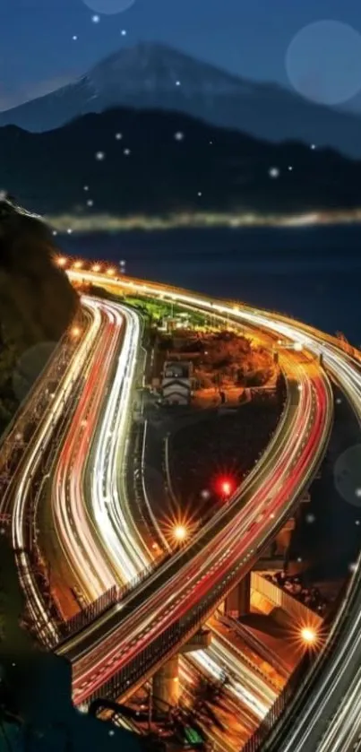 Winding highway with city lights at night.