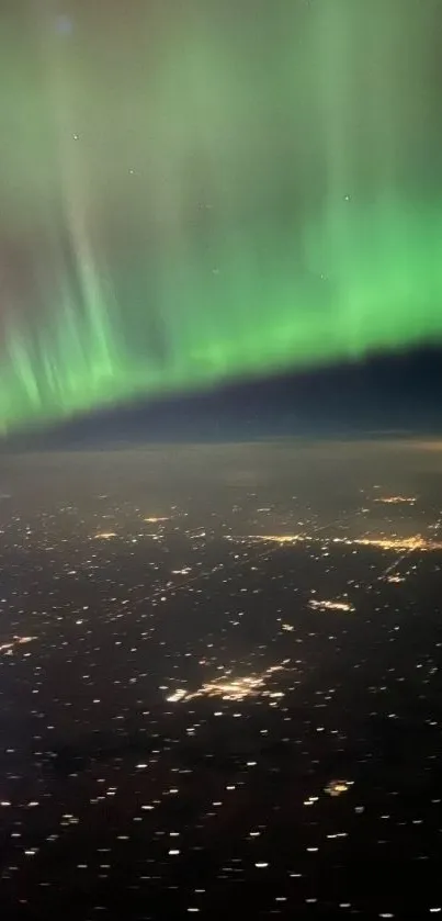 Aerial view of the Northern Lights over a city at night.