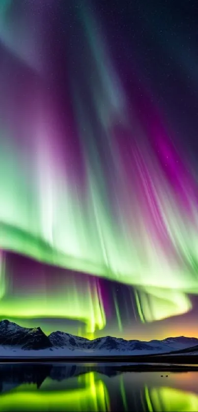 Vibrant Northern Lights over snowy mountains and a lake in this mobile wallpaper.