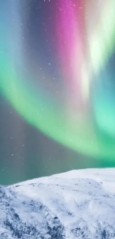 Northern Lights over snowy mountain with vibrant colors in night sky