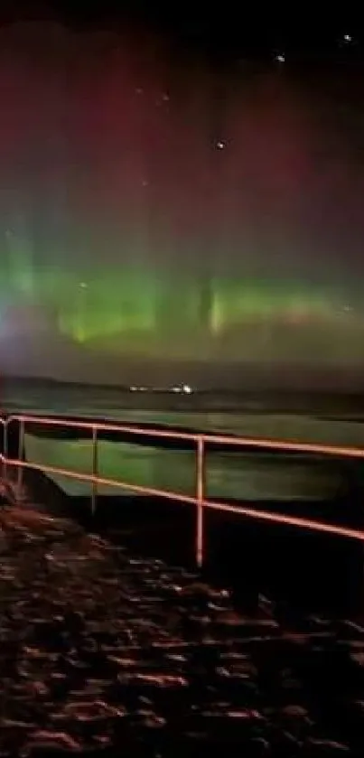 Peaceful pier under aurora-lit sky.