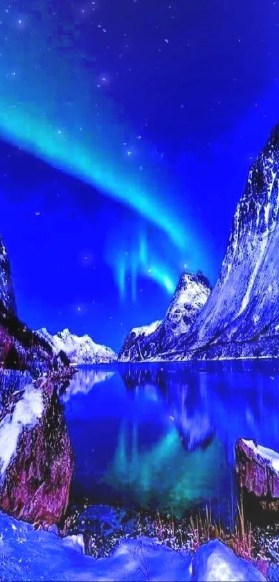 Vivid blue aurora over snowy mountains reflected in a serene lake.