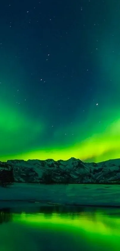 Vibrant green aurora over snow-capped mountains and reflective water under a starry sky.