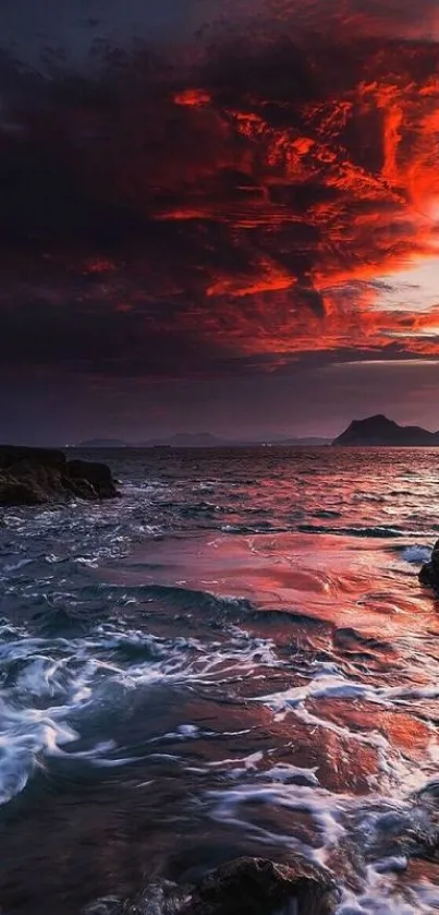 Stunning ocean sunset with vibrant red sky and waves.