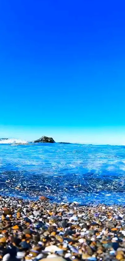 Ocean view with pebbled beach and clear blue sky.