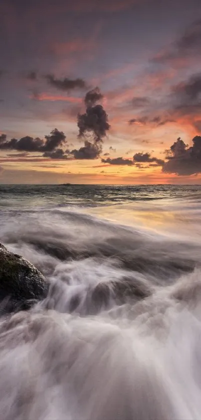 Vibrant ocean sunset with crashing waves under a colorful sky.